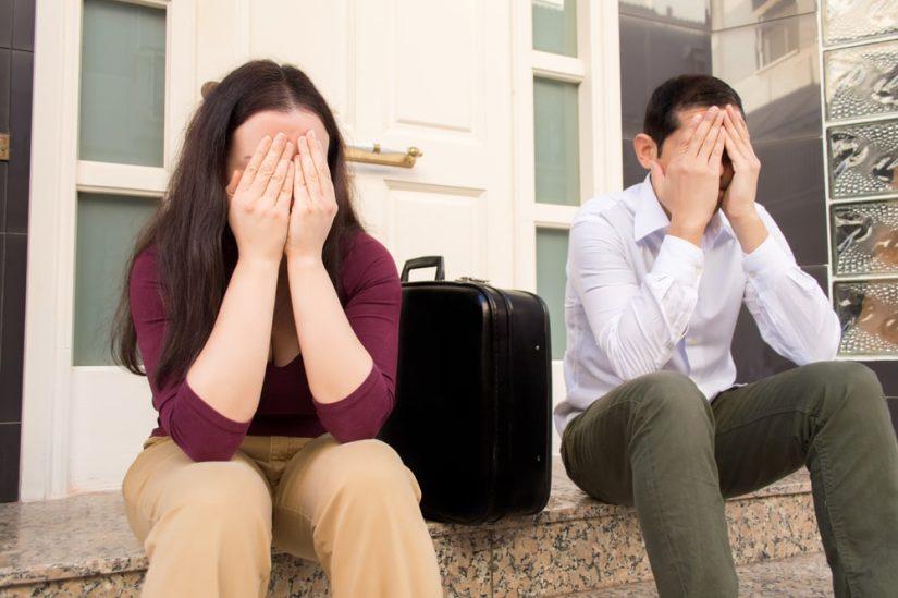 Woman And A Man Sitting And Holding Their Faces