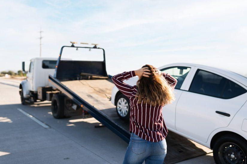 Woman Upset Watching Her White Car Being Towed