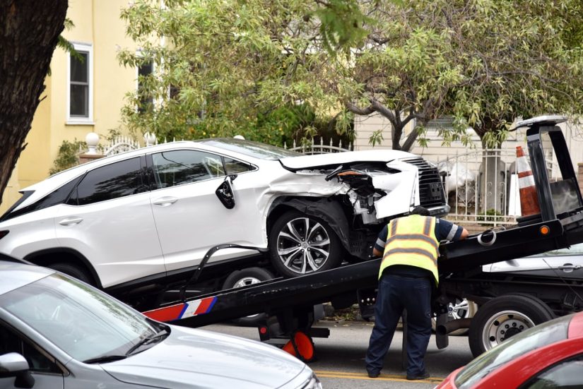 Damaged Car Being Lifted Onto the Tow Truck
